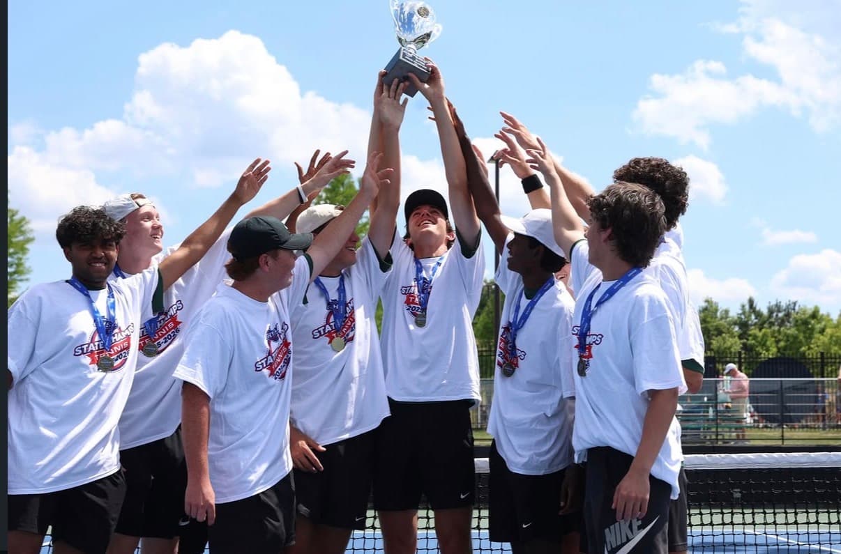 West Forsyth high school tennis team celebrating with a championship trophy